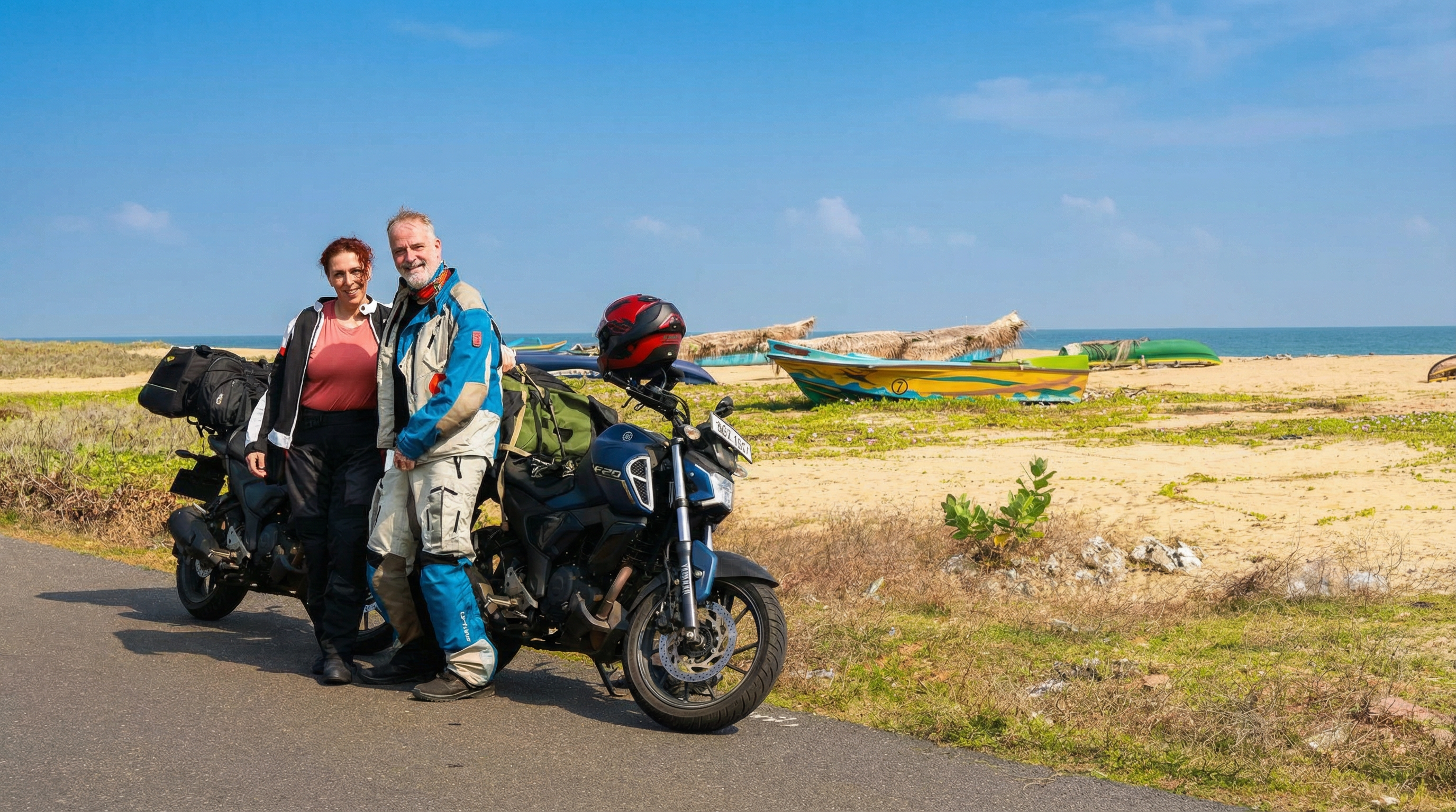 David and Dalma with a motorcycle on a beach in Sri Lanka.